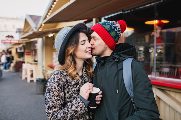 Free photo lovely joyful couple chilling, hugging on street in christmas time. true love emotions, having fun, enjoying togetherness, dating, romantic relationship, happines together.