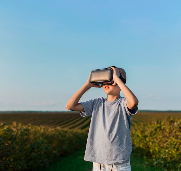 Free Photo lovely little boy having fun with virtual reality glasses