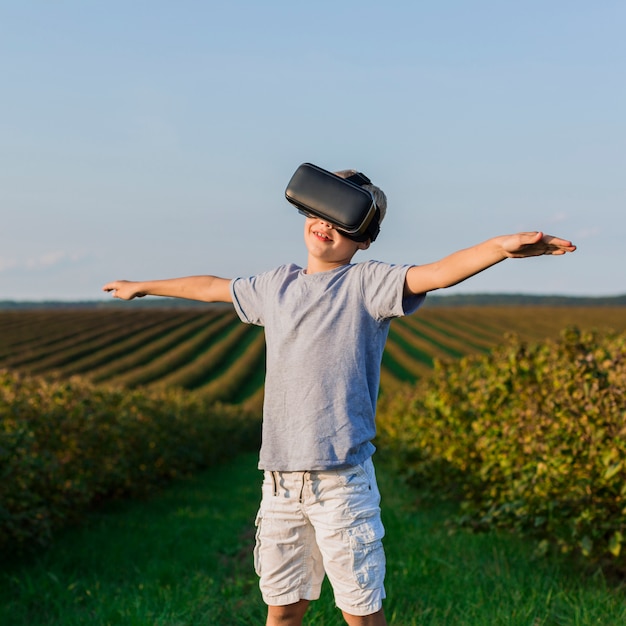 Free Photo lovely little boy having fun with virtual reality glasses