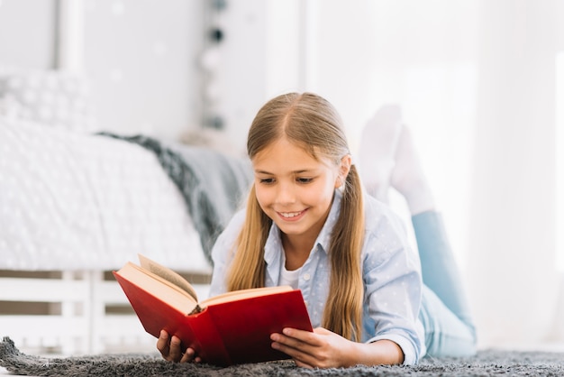 Lovely little girl reading a book