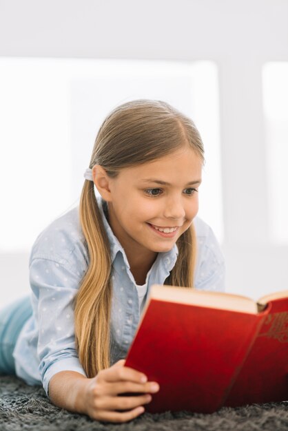 Lovely little girl reading a book