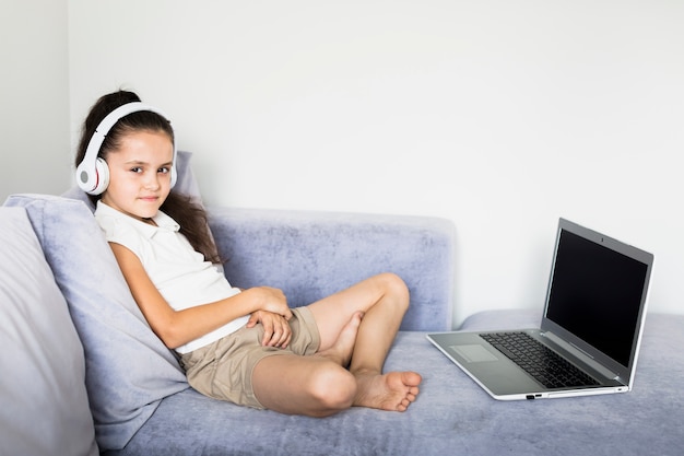 Lovely little girls using her laptop