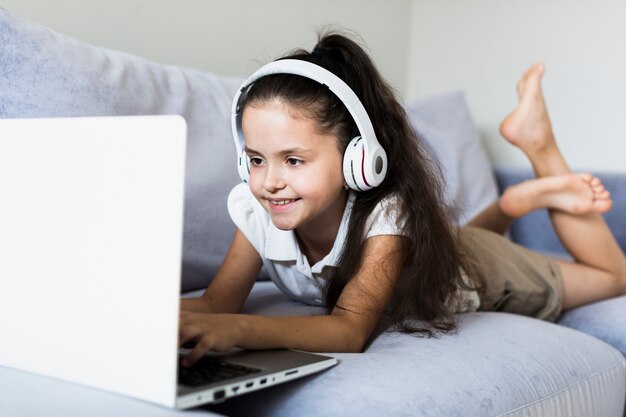 Lovely little girls using her laptop