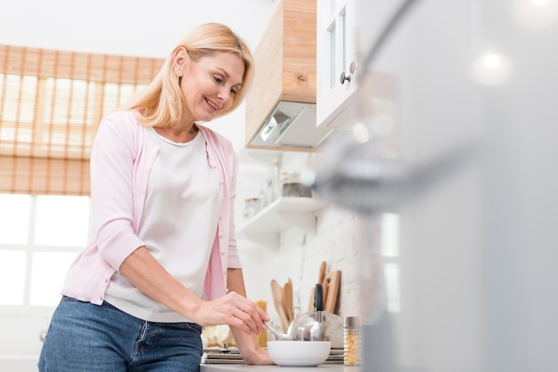 Free Photo lovely mature woman serving breakfast at home