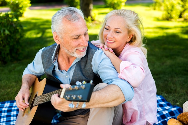 Free photo lovely old couple having a good time at nature