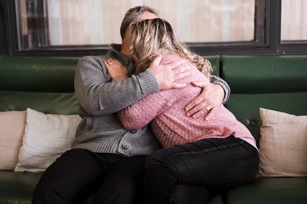 Lovely senior couple hugging indoors