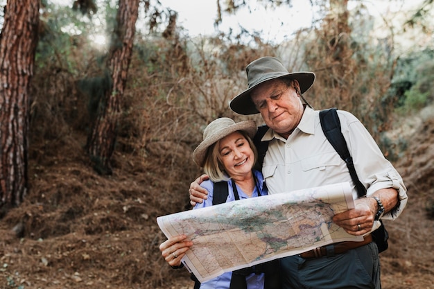 Free Photo lovely senior couple using a map to search for direction