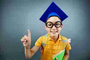 Free photo lovely student with blue graduation cap