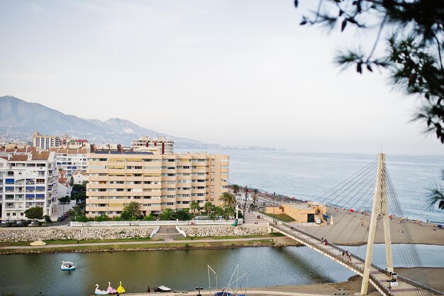 Lovely view at buildings by the sea and tall white bridge