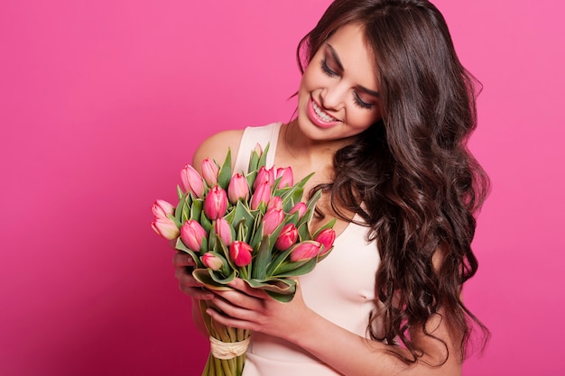 Lovely woman holding spring bouquet