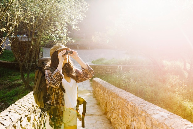 Lovely woman using binoculars