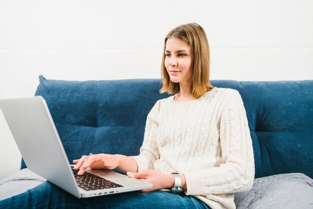 Free Photo lovely woman using laptop on bed