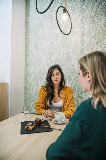 Lovely women speaking in cafe