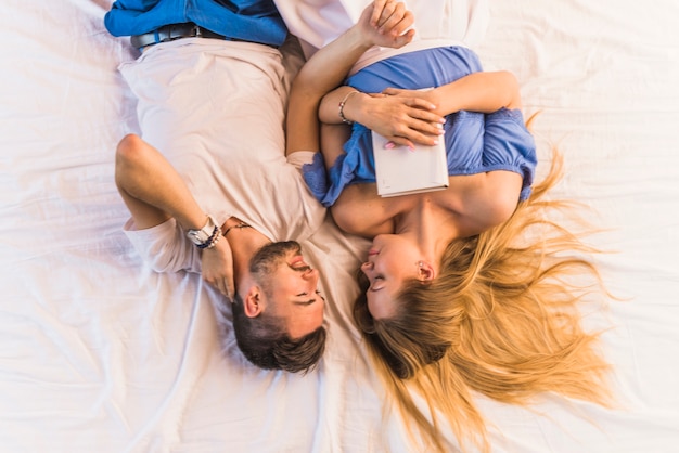 Free photo lovely young couple relaxing on bed