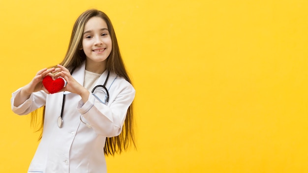 Lovely young girl holding heart