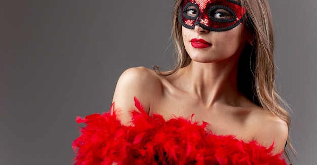 Lovely young woman with carnival mask