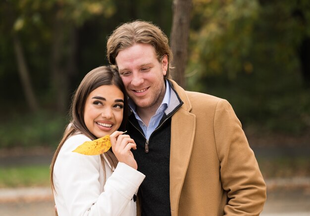 Loving Caucasian couple walking in the park in fall