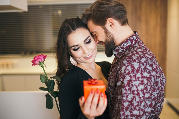 Loving couple embracing with presents