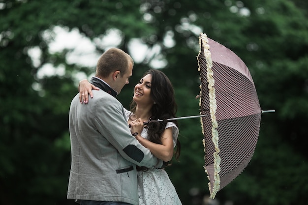 Loving couple holding an umbrella