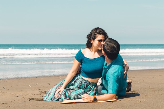 Loving couple kissing by seashore 