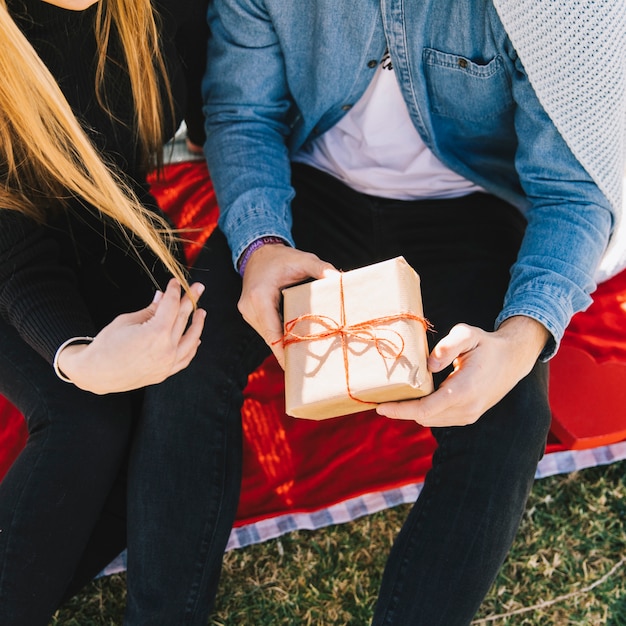 Free photo loving couple posing with present