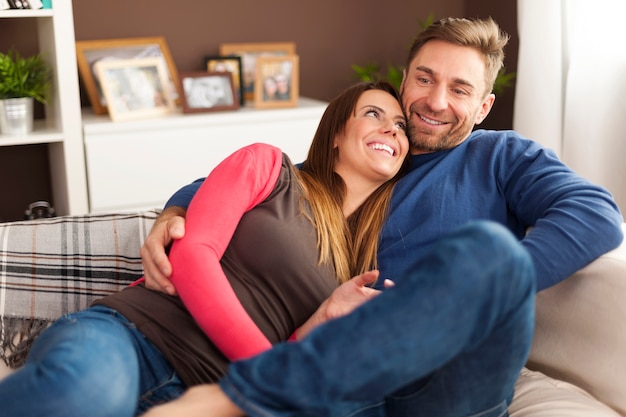 Loving couple relaxing on sofa