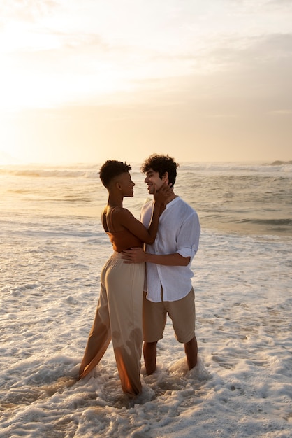 Loving couple showing affection on the beach near the ocean