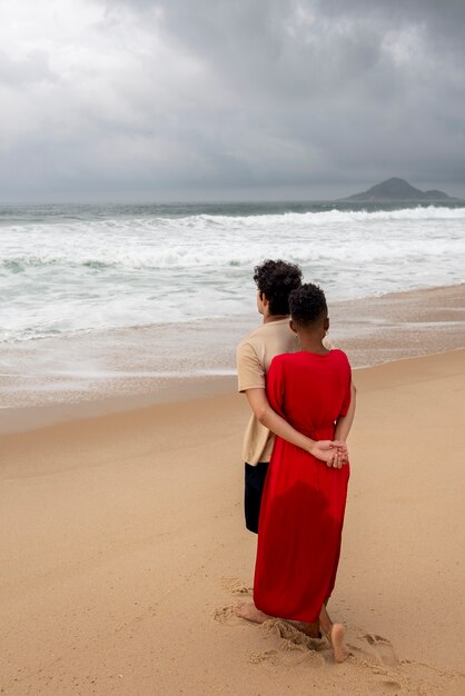 Loving couple showing affection on the beach near the ocean