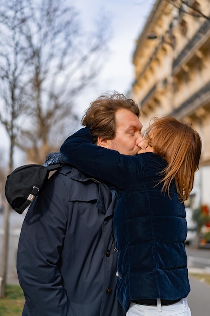 Free photo loving couple on the street hugs and kisses. paris.