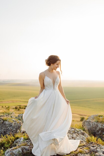 Loving couple wedding newlyweds outside at sunset in beautiful summer day