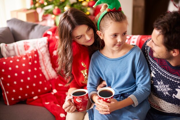 Loving family drinking dark chocolate at Christmas