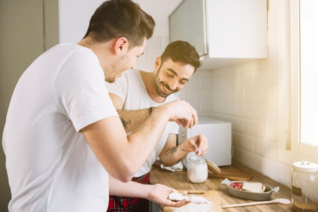 Loving gay couple making breakfast together