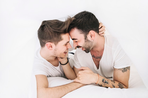 Loving homosexual couple under blanket