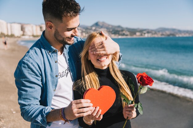 Loving man doing surprise for girlfriend