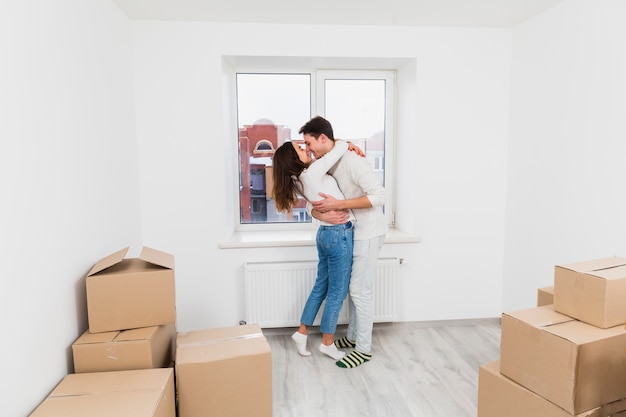 Loving young couple embracing each other in their new apartment