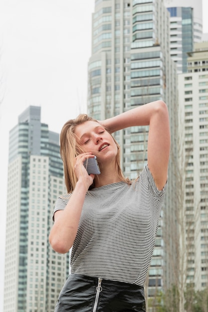 Low angle beautiful woman talking over phone