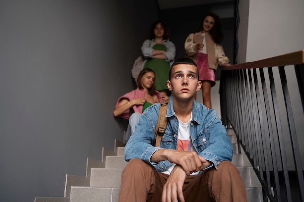 Low angle boy being bullied on stairs