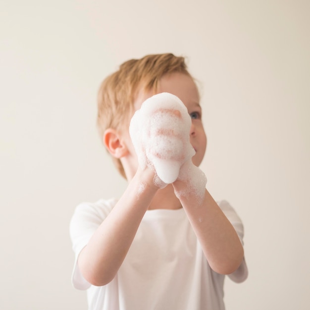 Low angle boy with foam on hands