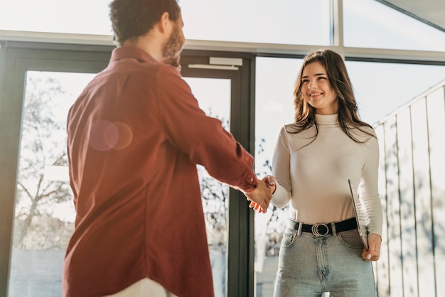 Low angle business people hand shake