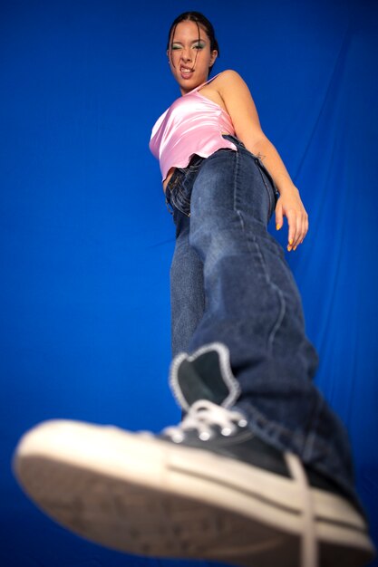 Low angle cool woman posing in studio