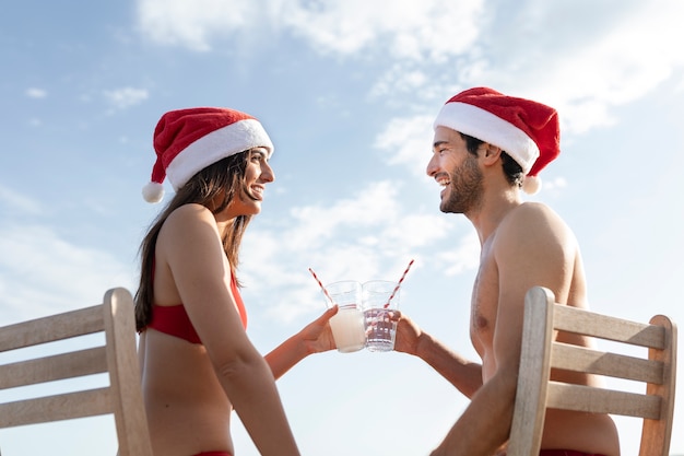 Low angle couple clinking glasses