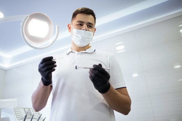 Free photo low angle of dentist performing a procedure