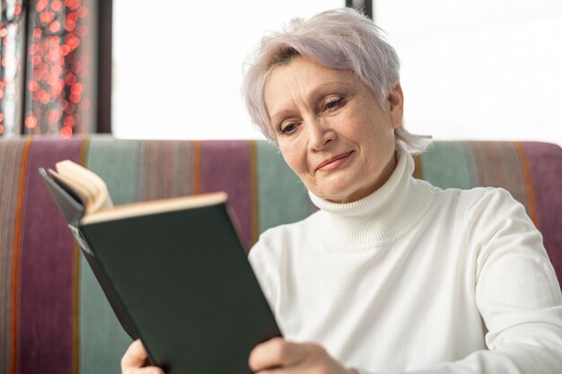 Low angle elder female reading