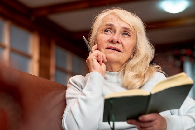 Low angle elder woman holding agenda