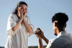 Free photo low angle excited woman accepting proposal