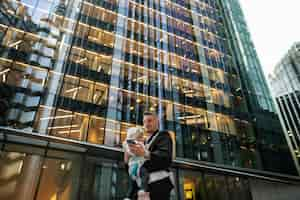 Free photo low angle father with baby in city