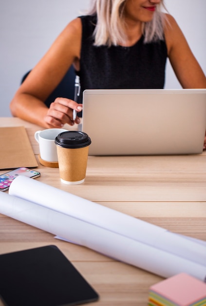 Low angle female at office working on laptop