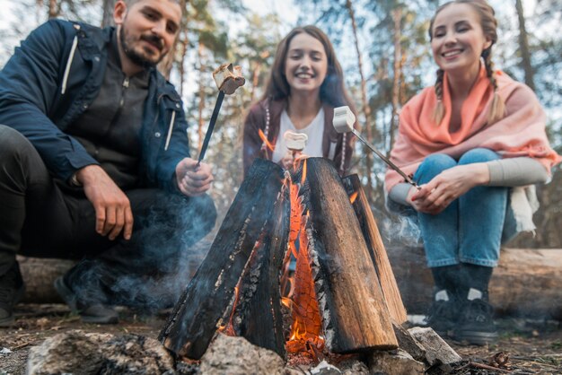 Low angle friends eating marshmallow