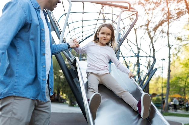 Low angle girl having fun on slide