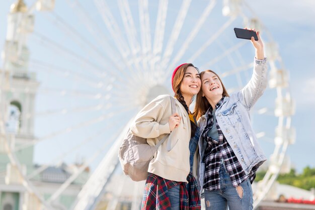 Low angle girlfriends taking selfie